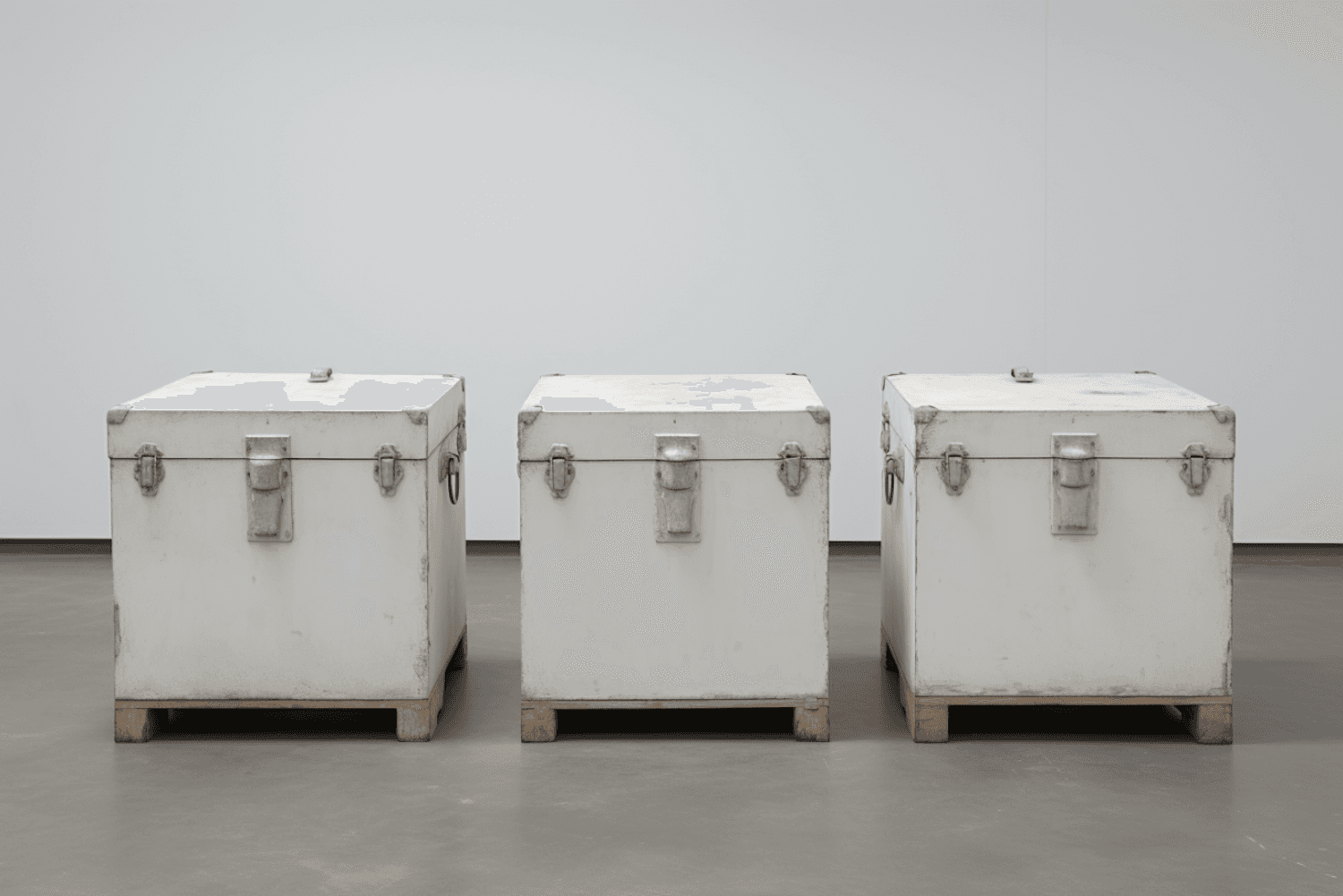 Shipping cases lined up against a plain wall