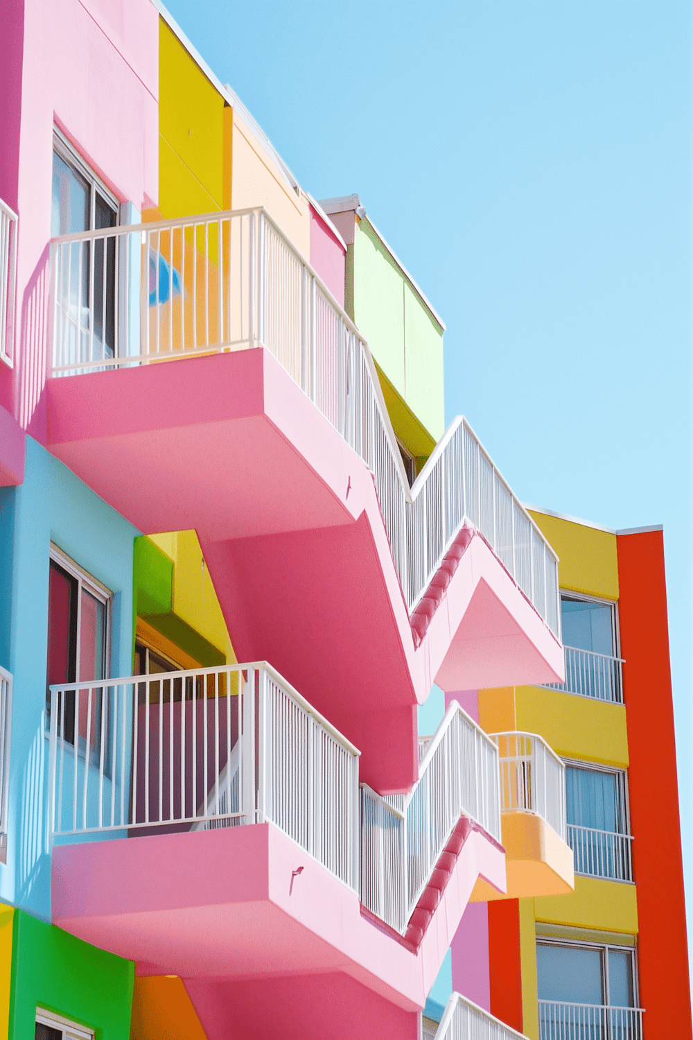 A modern apartment building with balconies against a clear sky